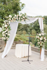 wedding day ceremony flower arch with lake landscape in background