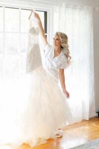 bride holding her gown on her wedding day
