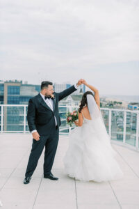 groom twirling bride during wedding portraits