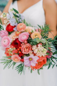colorful bridal bouquet in shades of pink, red, and orange