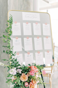 seating assignments on gold framed mirror with wax seals and flowers