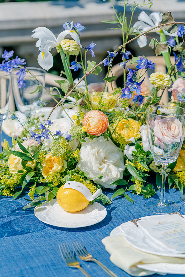 colorful wedding centerpiece incorporating lemons and calligraphy details