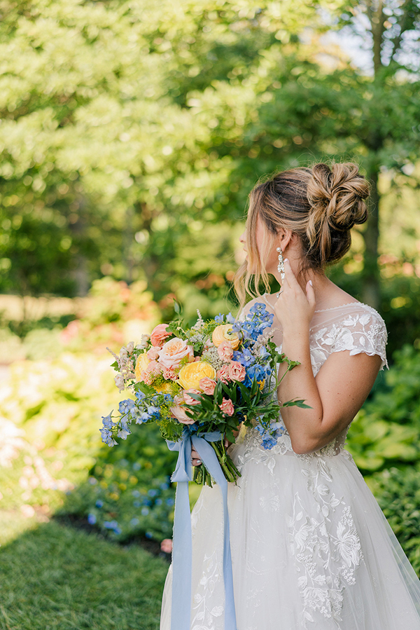 romantic bridal style with cap sleeve lace gown, romantic updo and colorful bouquet