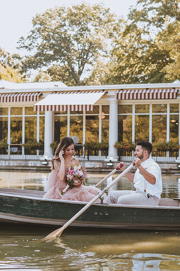 CWeddingsMag.com | bride fixing hair in rowboat during NY engagement session in Central Park