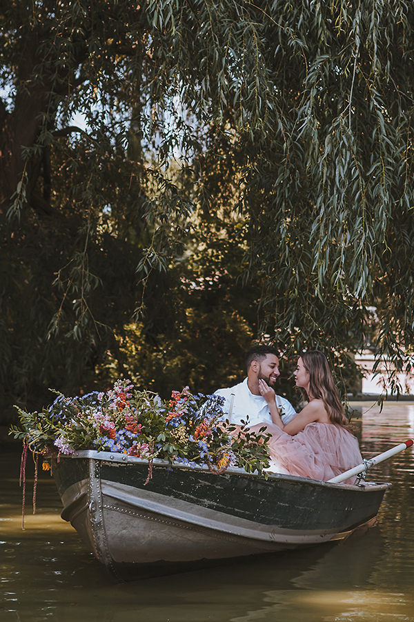 CWeddingsMag.com | couple cuddling in rowboat during engagement session in Central Park