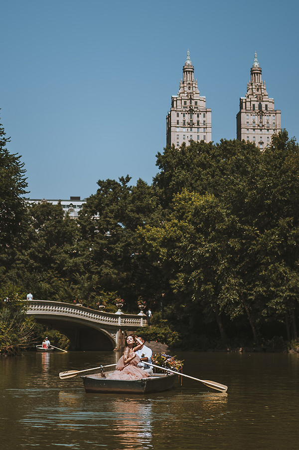 CWeddingsMag.com | engaged couple in rowboat during engagement session in Central Park