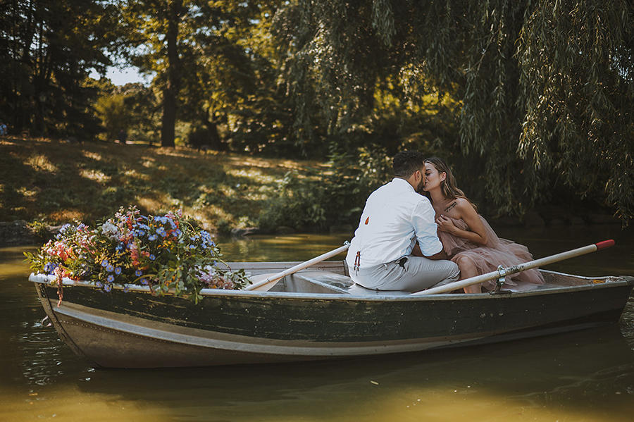 CWeddingsMag.com | couple kissing in rowboat during Central Park engagement session