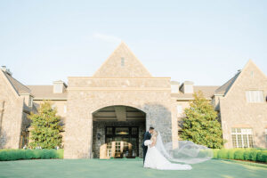 bride and groom wedding portrait in front of Alpine Country Club