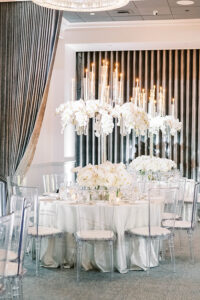 lavish white wedding tablescape with orchids and suspended taper candles