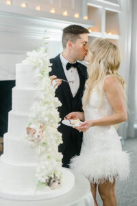 bride and groom kissing during cake cutting