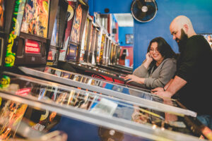 couple playing video games at Yestercades during engagement session