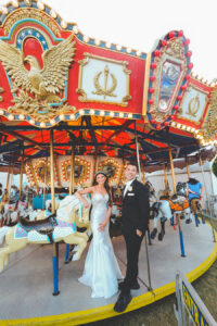 newlywed portraits on merry go round at local NJ carnival
