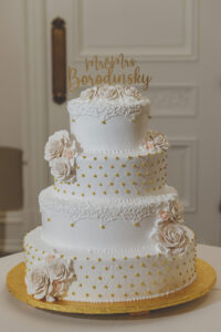 Classic white and gold four-tier wedding cake at Park Chateau