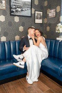 newlyweds cuddling on couch during reception portraits at Perona Farms